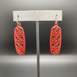 Ornate red metal dangle earrings